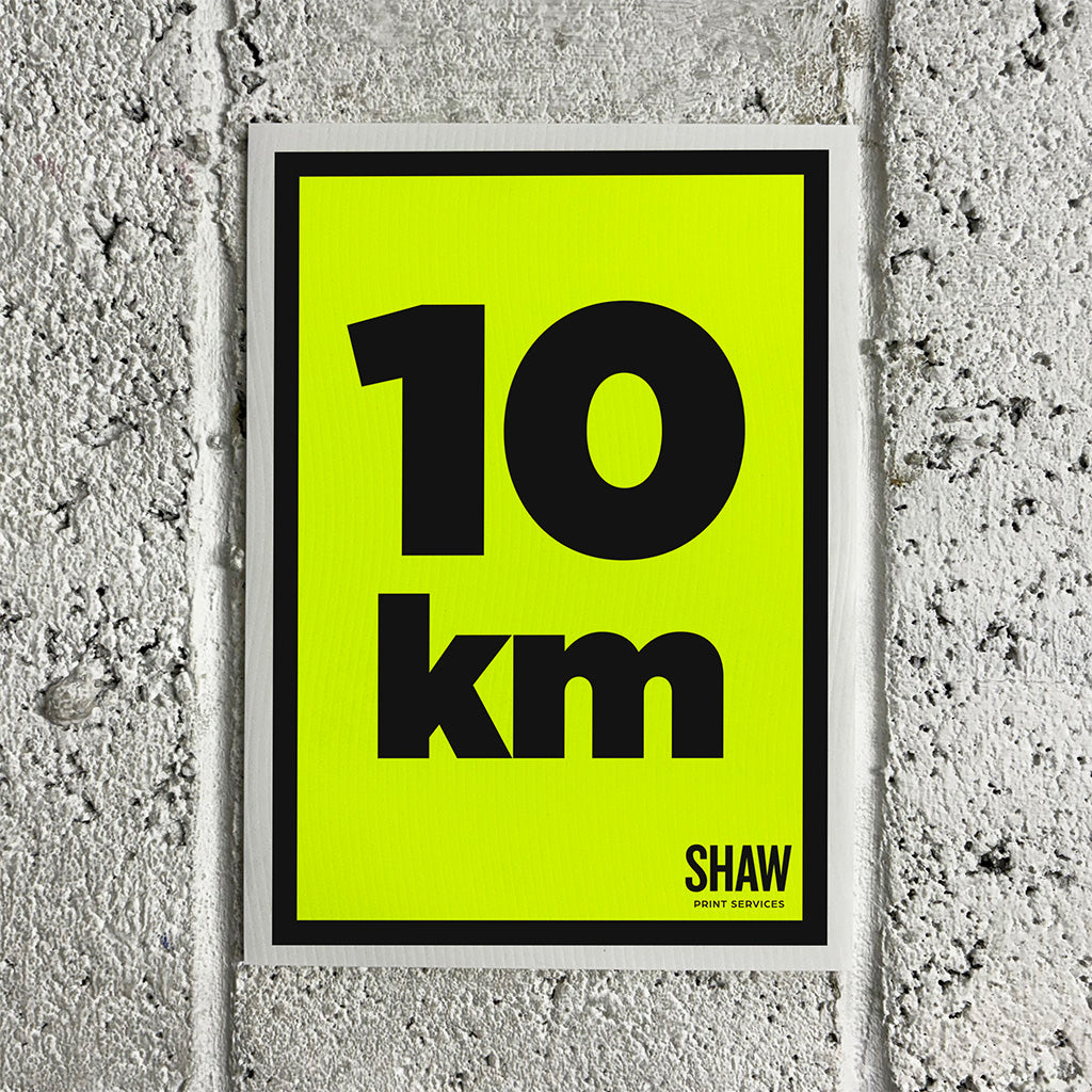 A 10K distance marker sign on a yellow background with black text.