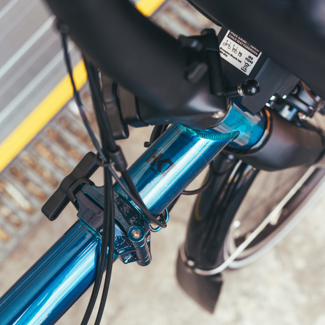 Close-up of a bicycle's handlebar and front fork with a blurred background