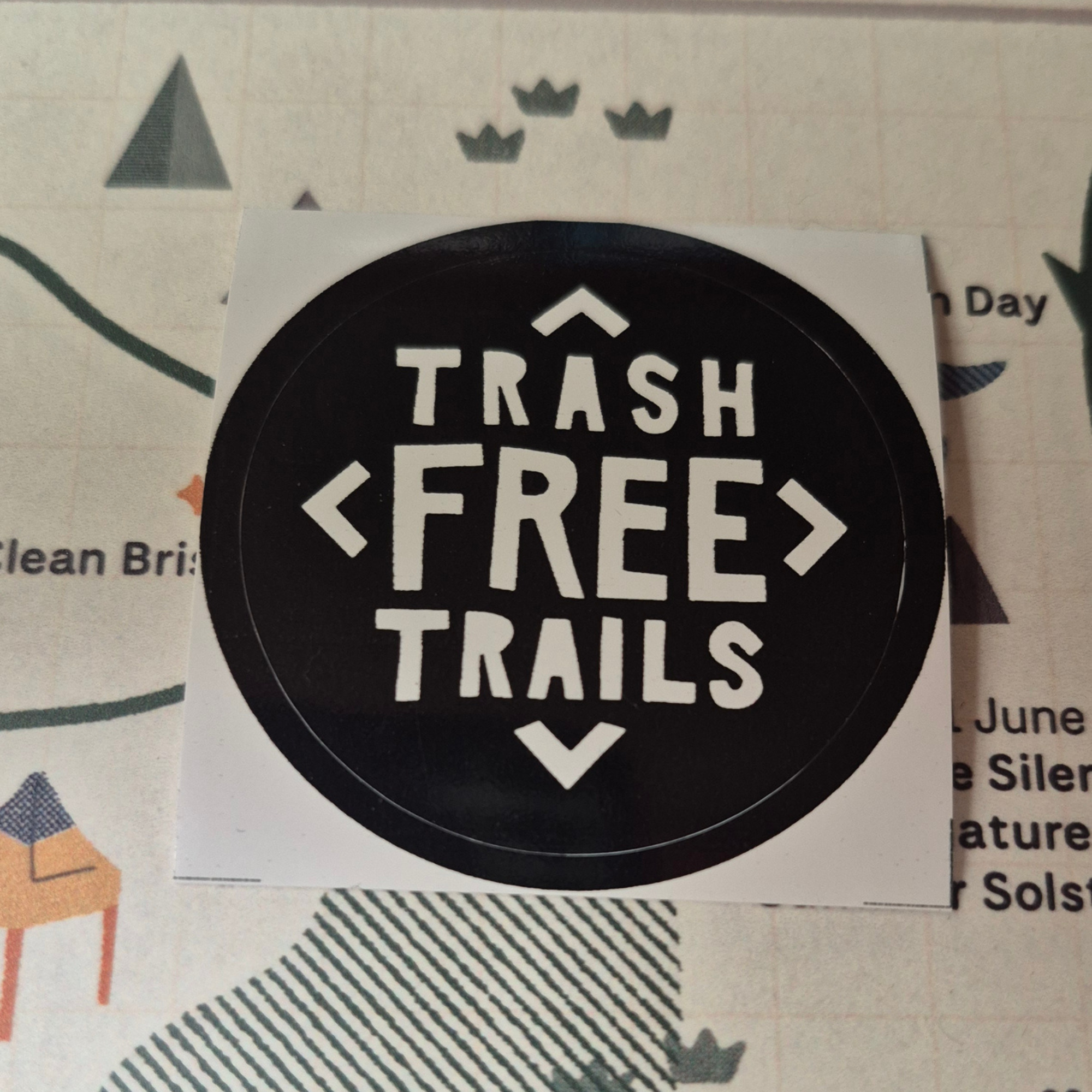 Round sticker with 'Trash Free Trails' text on a white background