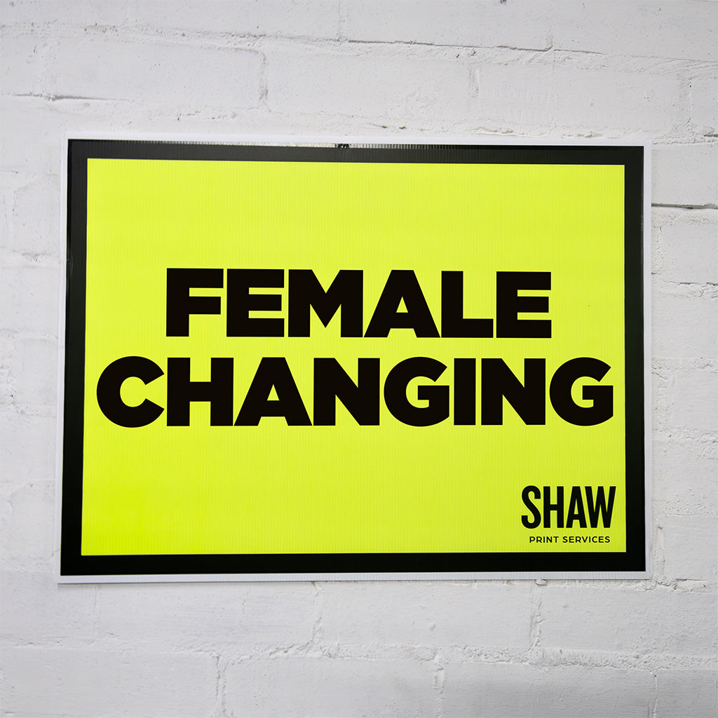 A2 female changing sign in yellow with black test.