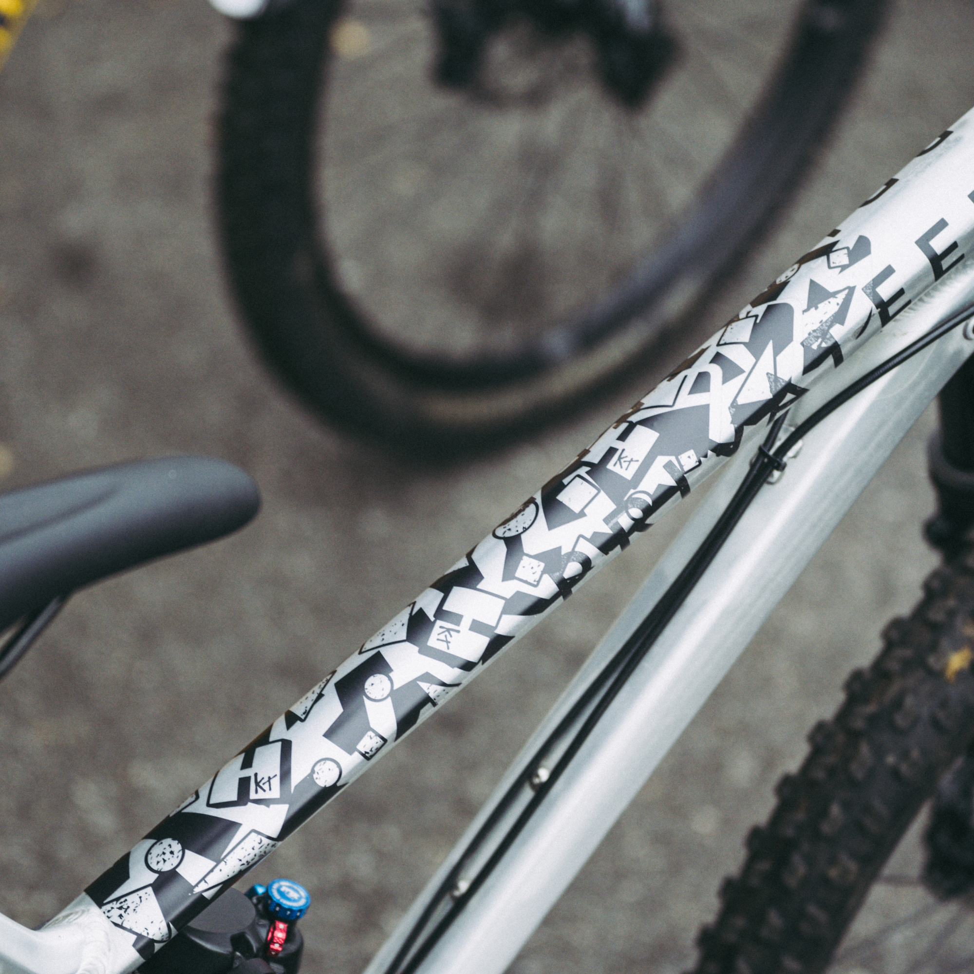 Born in the 80's black and white bike frame kit on a silver mountain bike.