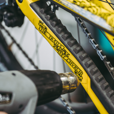 The Holy Grail Black Gloss bike frame protection kit on a yellow bike frame.