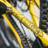 Holy grail black gloss bike frame protection kit on a yellow bike.