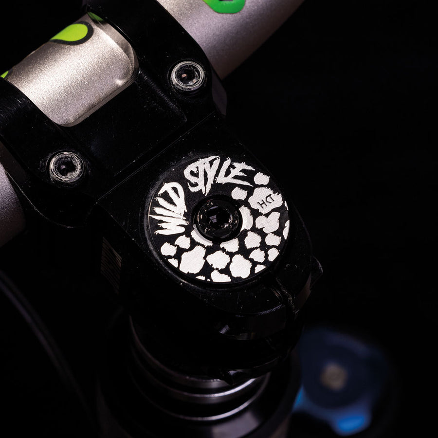 Wild Style Text black stem cap with black bolt. 