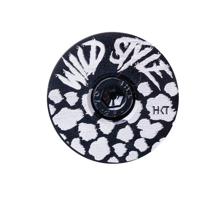 Wild Style Text black stem cap with black bolt on a white background.