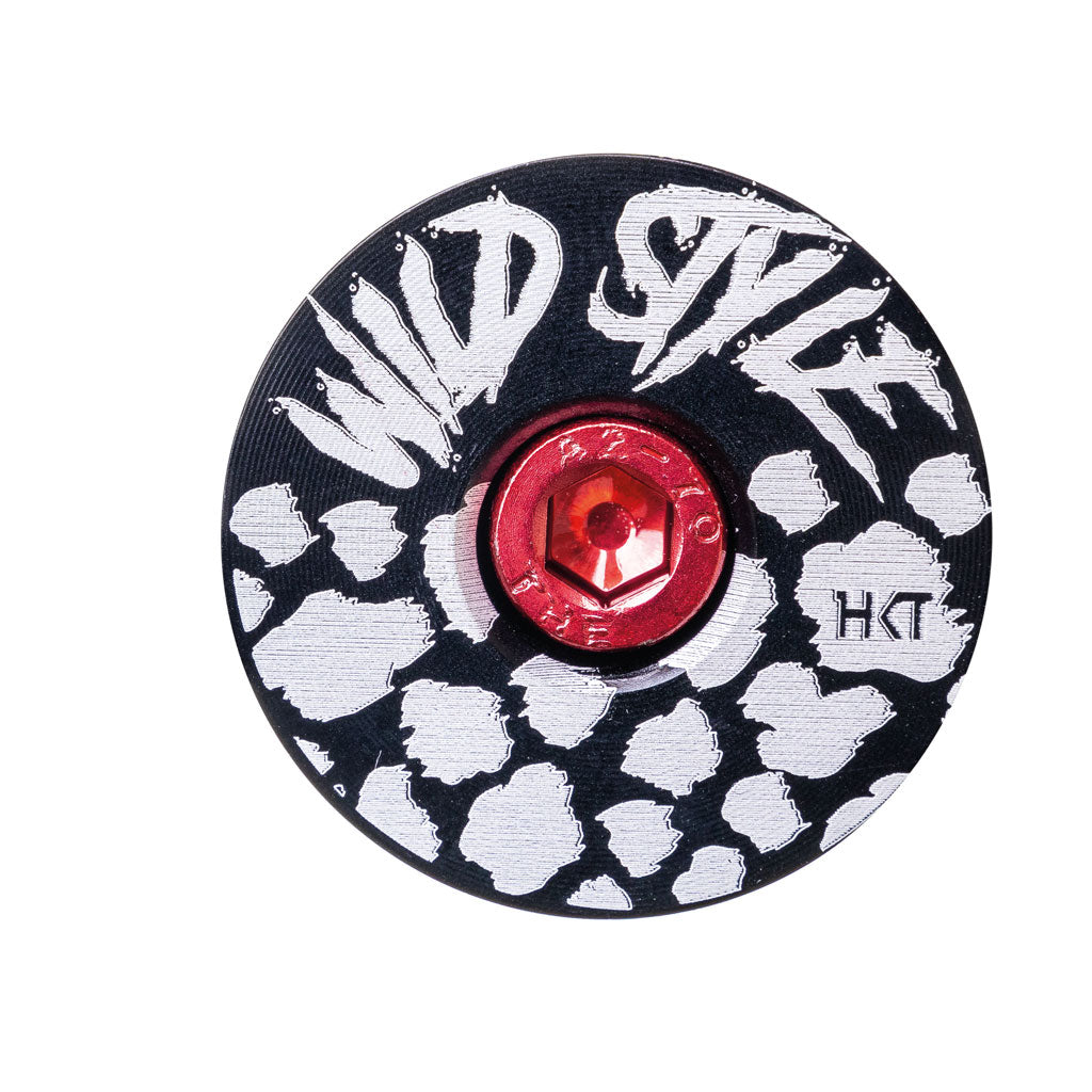 Wild Style Text black stem cap with red bolt.