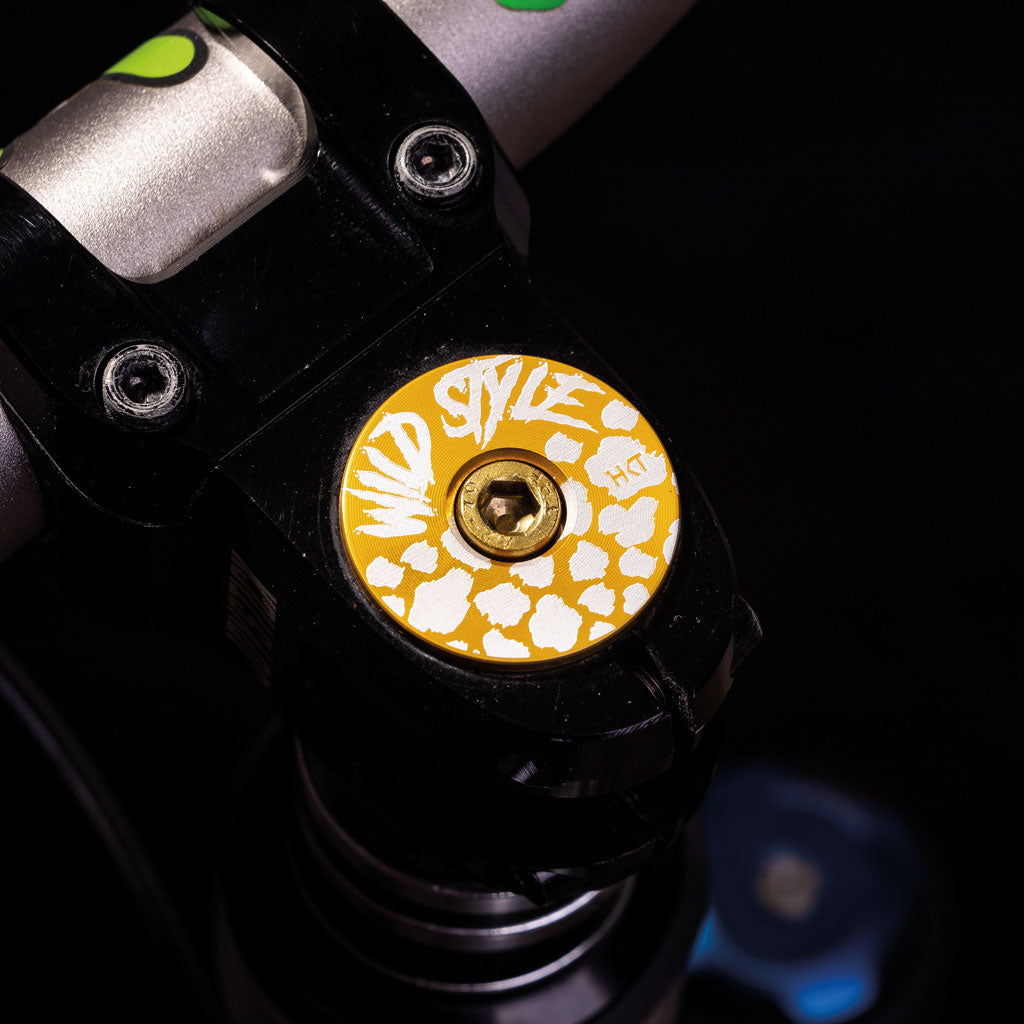 Wild Style Text gold stem cap with gold bolt.