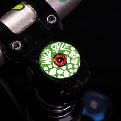 Wild Style Text green stem cap with red bolt.
