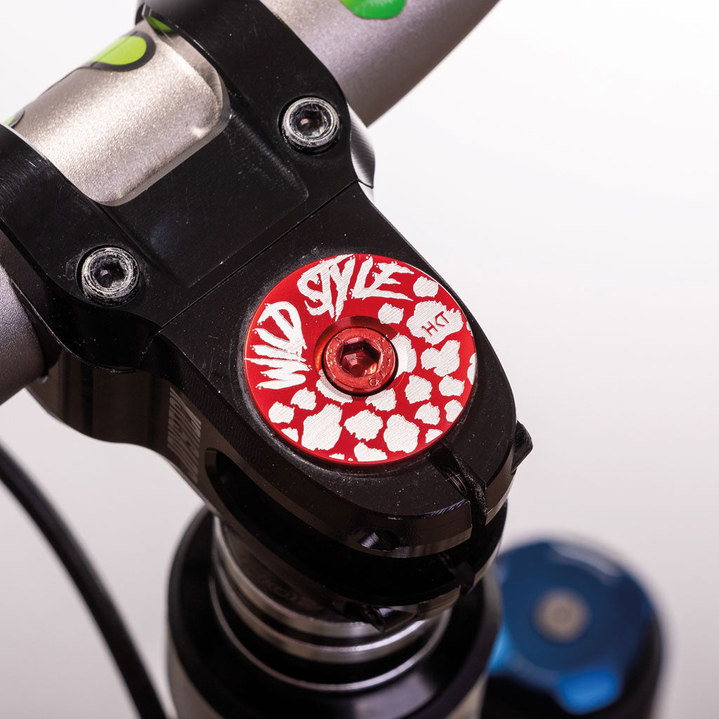 Wild Style Text red stem cap with red bolt.